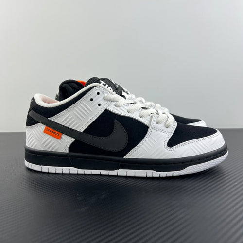 Black and white low-top sneakers with lace-up design and black Nike swoosh
