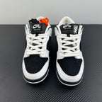 Pair of black and white low-top sneakers with white laces and black heel panels