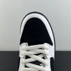 Close-up of black and white sneaker toe and lace-up front with textured panels