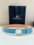 Turquoise leather belt with round silver medallion buckle and small perforation holes