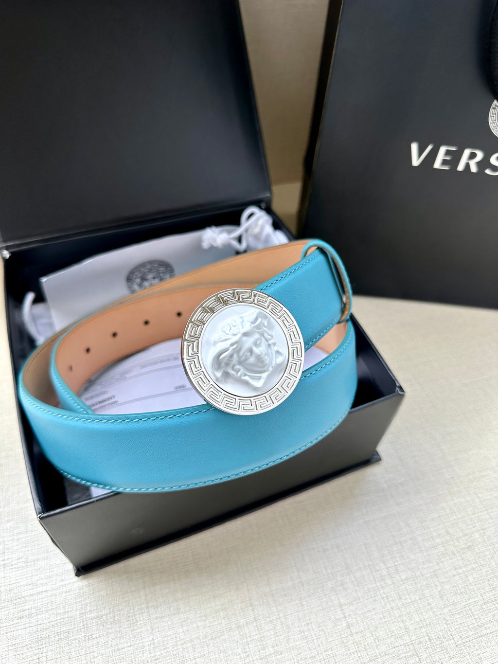 Turquoise leather belt in gift box with round silver medallion buckle and perforation holes