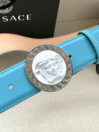 Turquoise leather belt with round silver medallion buckle featuring Medusa relief