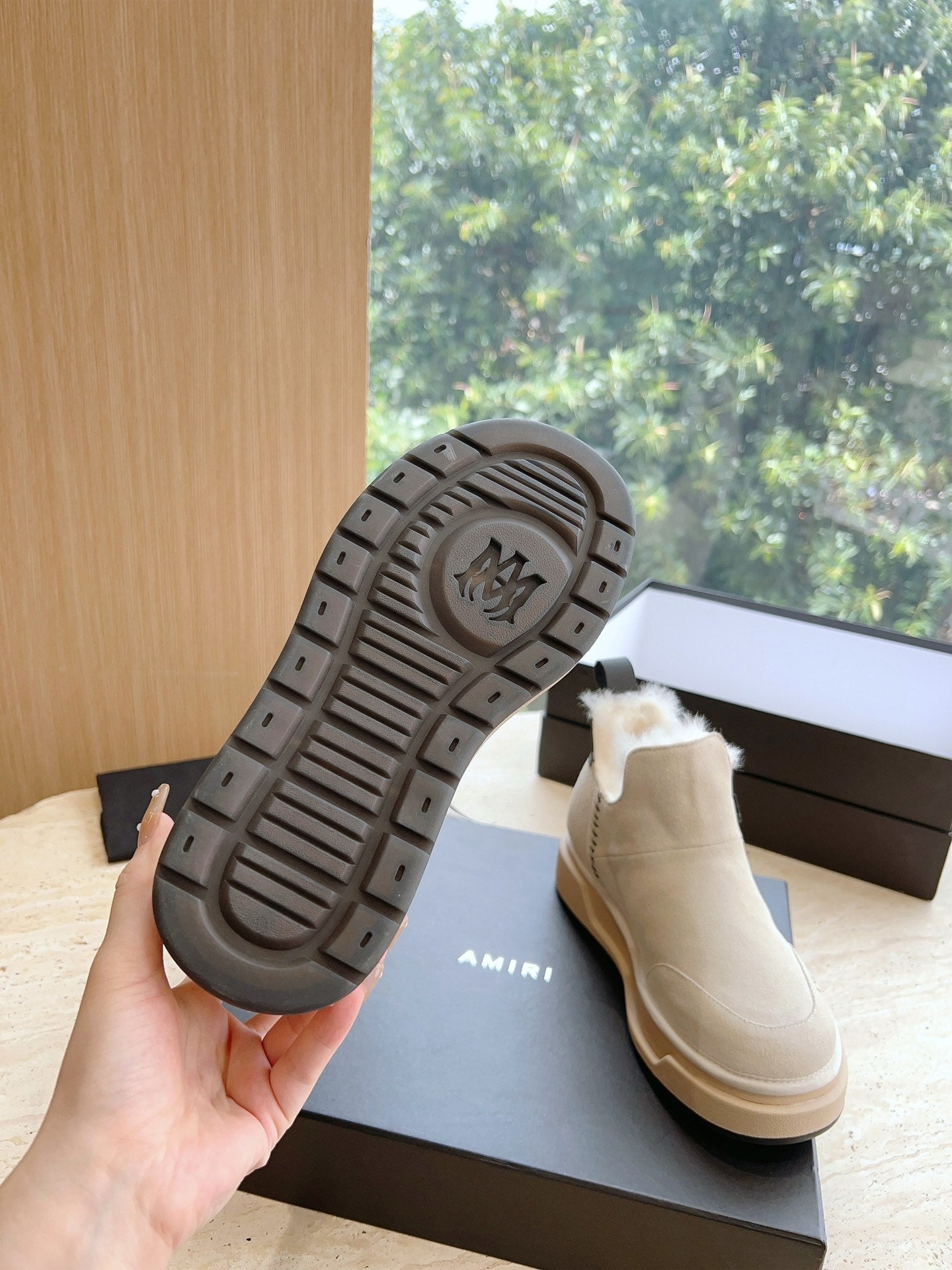Amiri boot outsole view on light beige lace-up upper with textured tread sole