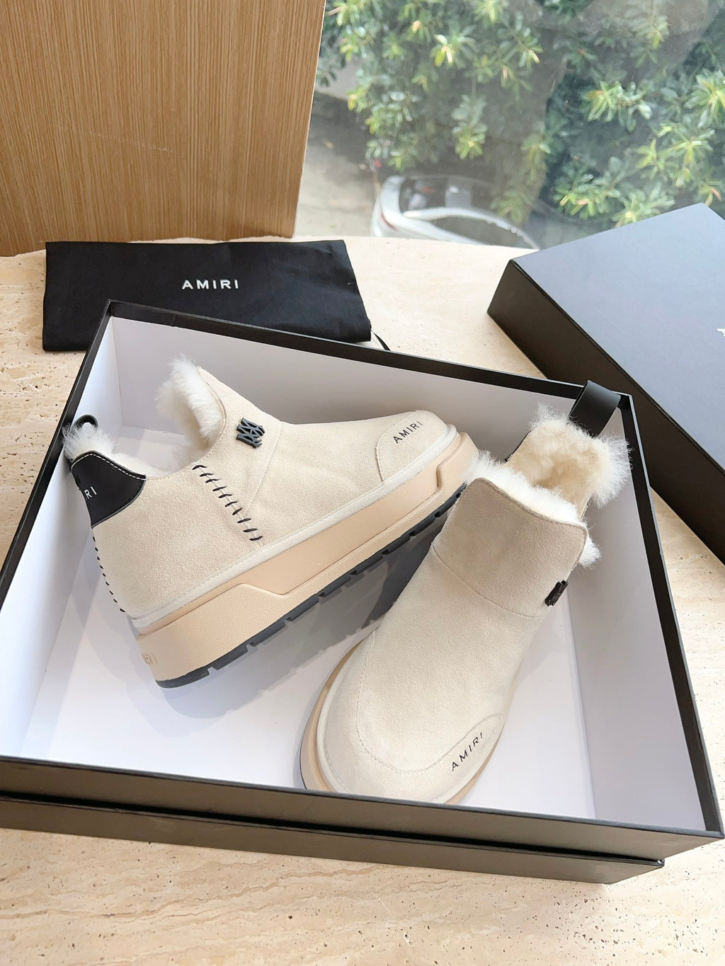 Amiri high-top boots in light beige with faux fur cuff, lace-up detail, rubber sole
