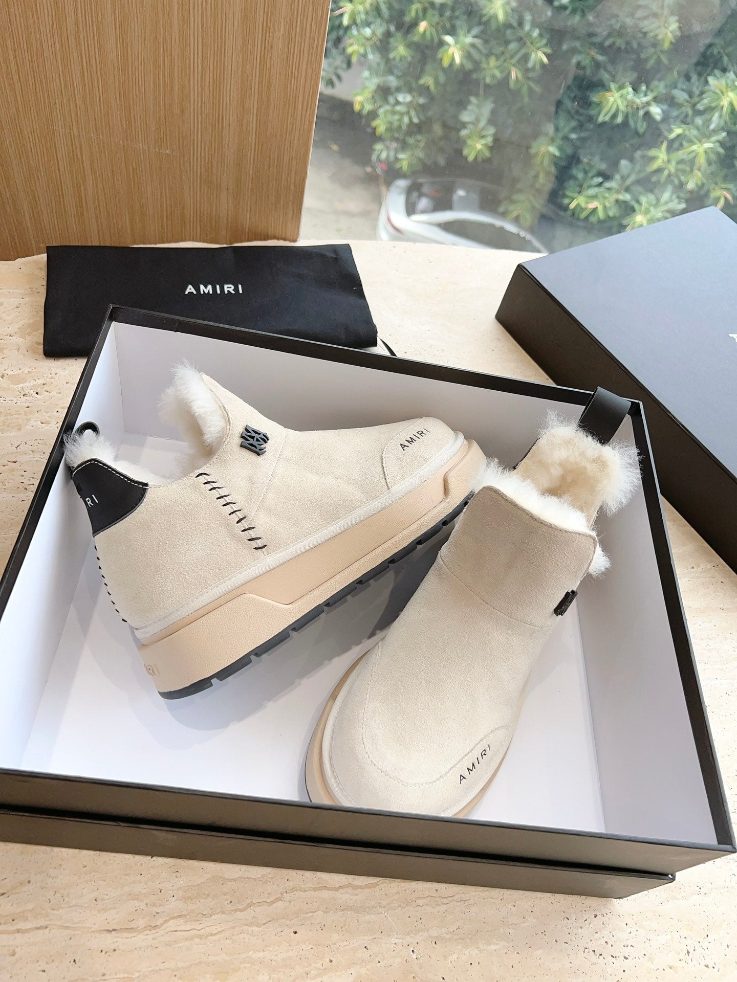Amiri high-top boots in light beige with faux fur cuff, lace-up detail, rubber sole