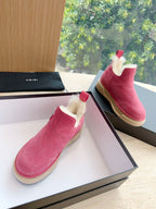 Pink suede Chelsea boots with faux shearling collar and beige rubber sole