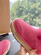 Pink suede Chelsea boot with faux shearling collar and stitched logo detail