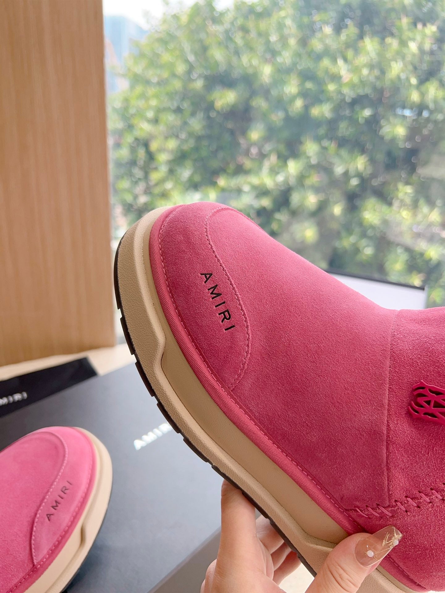 Pink suede Chelsea boot with faux shearling collar and stitched logo detail