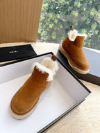 Amiri tan suede ankle boots with white shearling cuffs, shown on their side