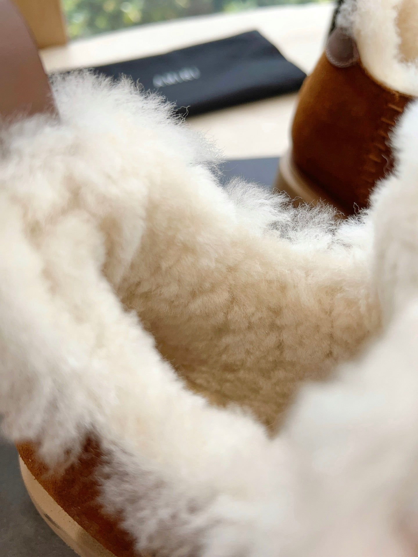 Amiri tan suede boot with thick white shearling lining, close-up