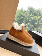 Amiri tan suede ankle boot with white shearling collar, side view on box lid