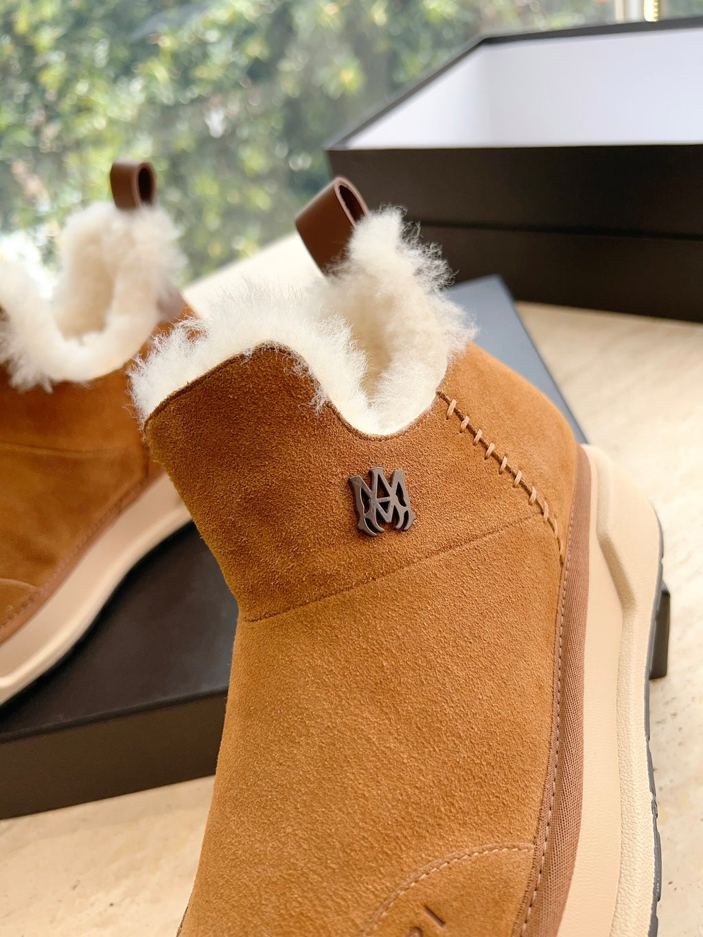 Amiri tan suede ankle boot with white shearling collar and crest emblem