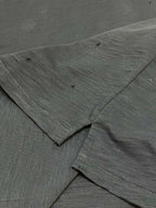 Dark T-shirt sleeve and hem seam with textured fabric detail