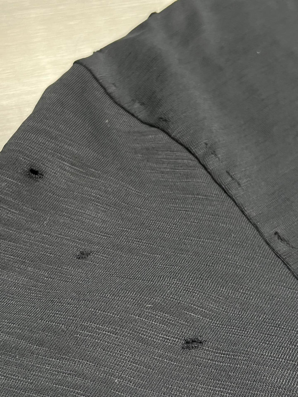 Dark short-sleeve T-shirt fabric with subtle speckled texture