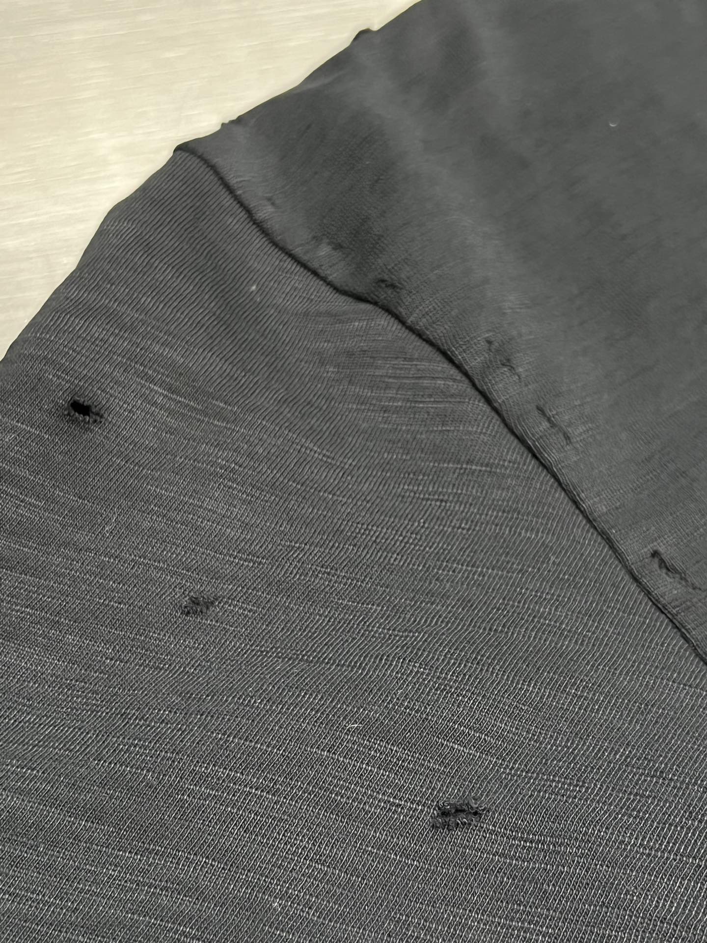 Dark short-sleeve T-shirt fabric with subtle speckled texture