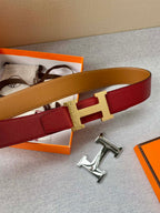 Hermes belt side view: red strap with gold H buckle and tan reverse strap.
