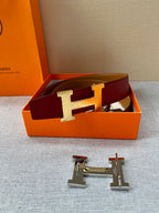 Hermes belt with red strap and gold H buckle, with spare buckle hardware.