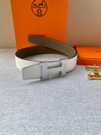 Two-tone leather belt: brown back with white strap and gold-tone H buckle.