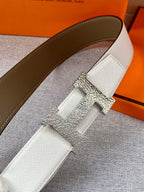 Brown leather belt with gold-tone buckle and textured keeper clasp detail.