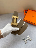 Brown leather belt with gold-tone H buckle; includes extra belt keepers.