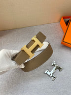 Brown leather belt with gold-tone H buckle and top-stitched keeper strap.