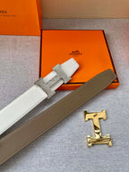 Brown leather belt with gold-tone H buckle and textured keeper strap.