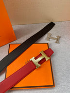 Black and red leather belts with H buckles in silver and gold tones