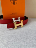 Red leather belt with gold-tone H buckle, shown with matching orange box