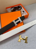 Black leather belt with silver-tone H buckle set on keeper strap