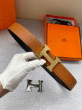 Tan leather belt with gold-tone H buckle; includes keeper and adjustable strap end.