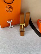 Tan leather belt with gold-tone H buckle and keeper; belt end and hardware shown.