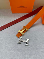 Orange leather belt with gold H buckle and burgundy underside
