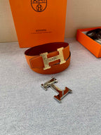 Orange leather belt with gold H buckle and metal clasp