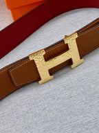 Hermes leather belt buckle detail with gold-tone H clasp on tan/brown strap