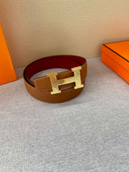 Brown leather belt with gold H buckle and red inner band
