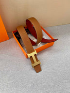 Brown leather belt with gold H buckle and red interior, folded view