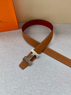 Brown leather belt with gold buckle and maroon underside