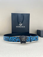 Versace belt with blue logo strap and ornate silver lion buckle, on display with box