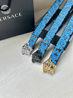 Versace belt trio with blue logo webbing and Medusa buckles in silver, black, and gold