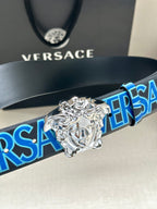 Versace belt detail with dark strap, blue logo pattern, and silver Medusa buckle