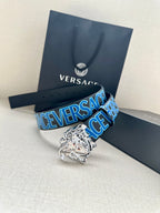 Versace belt with dark strap, blue logo print, and silver Medusa buckle