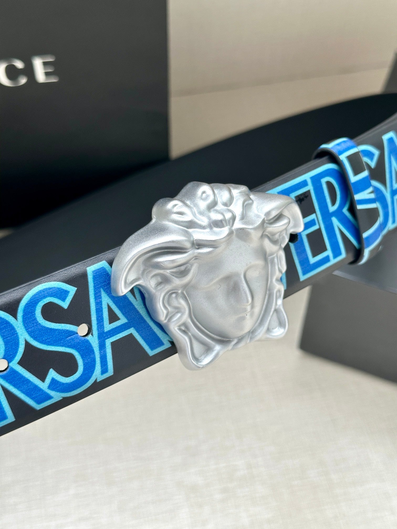 Versace belt buckle with silver Medusa head on blue logo strap
