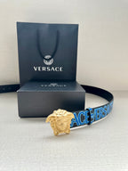 Versace belt on display: dark blue strap with Versace logo print and gold Medusa buckle.