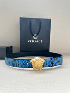 Versace belt with dark blue strap, repeating Versace print, and gold Medusa buckle.