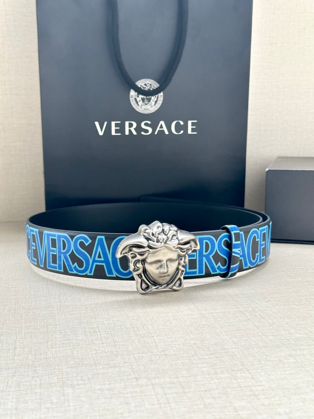 Versace belt: blue logo strap with silver Medusa buckle, front view