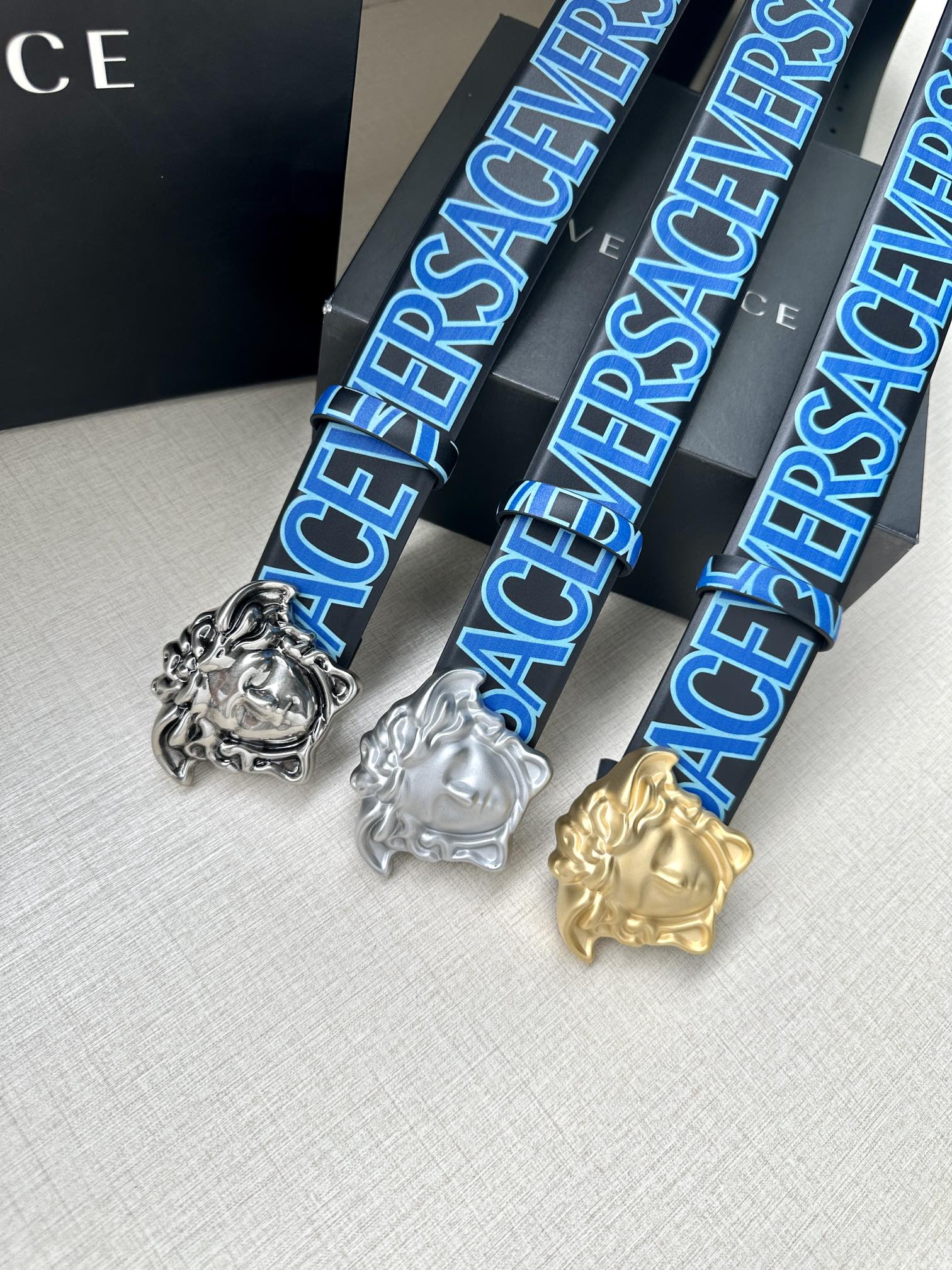 Versace belt set: blue, silver, and gold logo straps with Medusa buckles