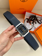 Navy leather belt with square silver buckle and dark enamel detail