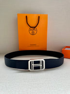 Navy leather belt with silver square buckle, laid flat for viewing