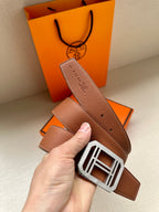 Brown leather belt with silver-toned square H buckle and perforated adjustment holes