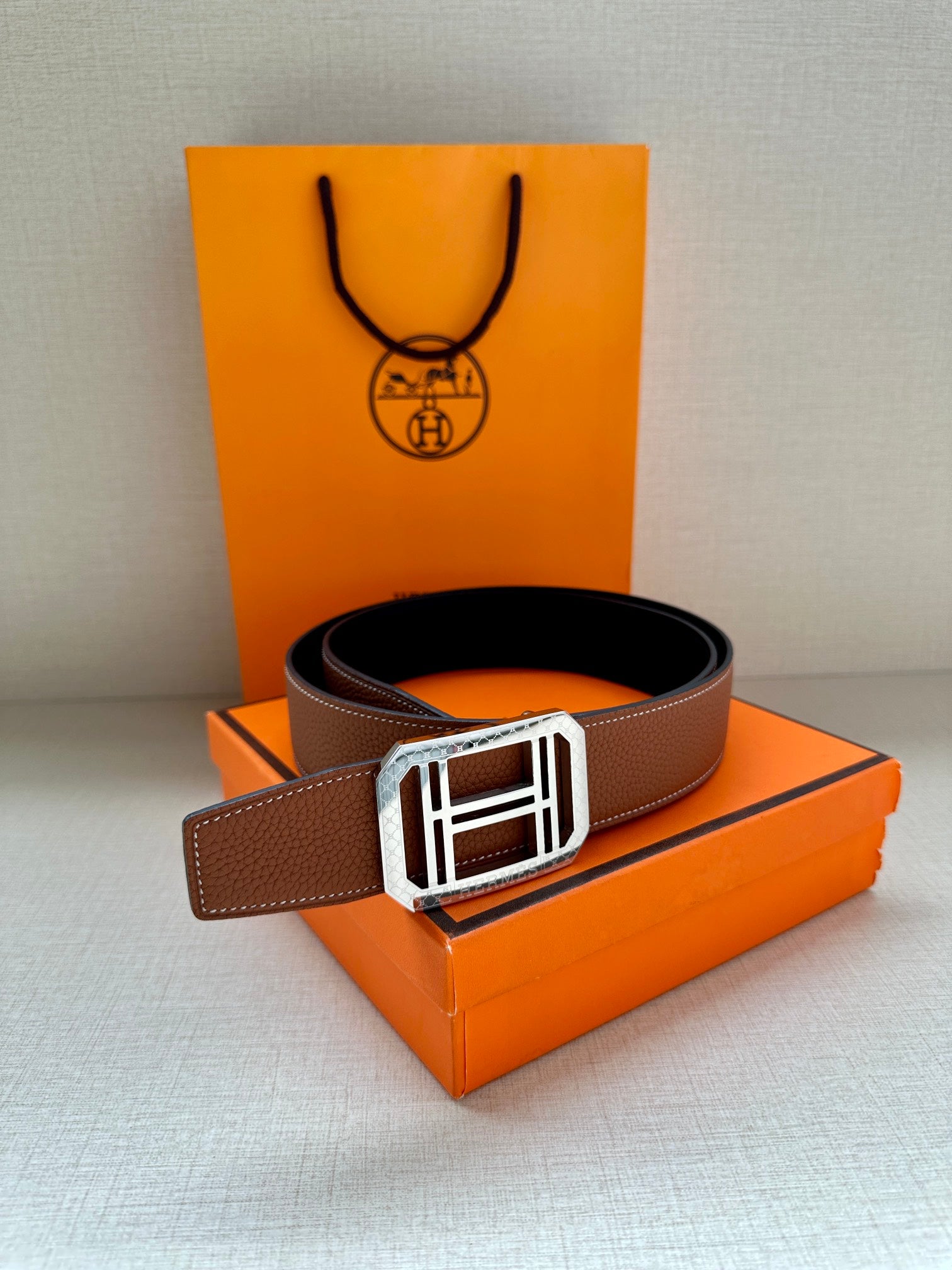 Brown leather belt with silver-toned square H buckle and loop keeper strap